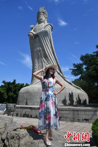 圖為嘉賓在媽祖石像前拍照?！蚊?攝