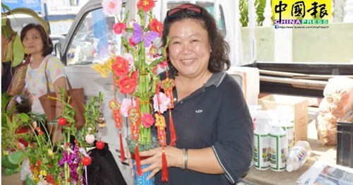 梁依凌：年花非常好賣，很多游客也選購。(馬來西亞《中國報》/歐盛財 攝)