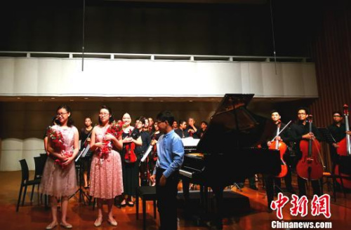 現(xiàn)場多位音樂人表示，姐妹倆十幾歲即與交響樂團合作開音樂會，臺風穩(wěn)健，頗具天分，全菲少見。這是演出結(jié)束，觀眾獻花祝賀。　關(guān)向東 攝