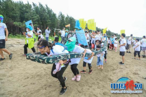 市民和游客體驗(yàn)潭門趕海運(yùn)動會合力過桿活動?！±钚娜?攝