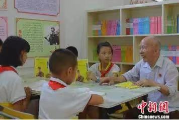 鐘挺華在東安二小圖書(shū)館為學(xué)生講雷鋒故事。嚴(yán)潔 攝