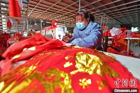 工人縫制燈籠布?！×趾霔v 攝