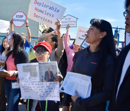 艾姆赫斯特居民高舉“凄慘的游民服務(wù)”(Deplorable