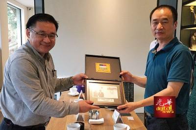 中國僑網(wǎng)雞場街文化坊工委會顧問顏天祿(左)贈送紀念品給寬窄巷子管委會副總經(jīng)理冉紅山。(馬來西亞光華網(wǎng)圖片)