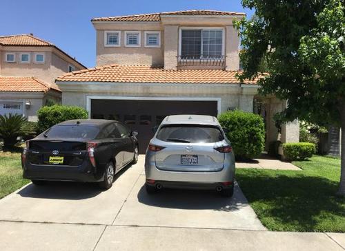 中國僑網(wǎng)住宅前停靠華人夫婦生前使用的車子。(美國《世界日報》/啟鉻 攝)