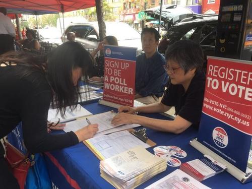 中國僑網(wǎng)李佳陵(右)在指導(dǎo)華裔民眾填寫翻譯員的報(bào)名表。(美國《世界日?qǐng)?bào)》/張?bào)?攝)