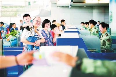 一個參加出境游的中國家庭正在辦理邊檢通關(guān)手續(xù)。