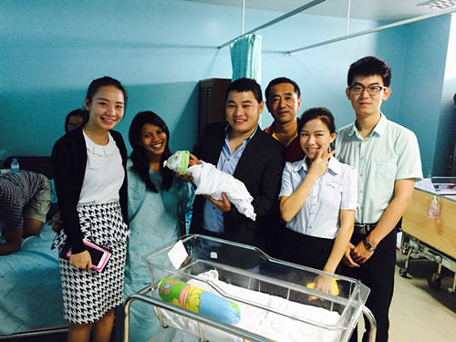 魏光磊(中間抱孩子者)教師節(jié)帶領(lǐng)老師看望生子的本土漢語(yǔ)教師同事。(圖片由受訪者提供)