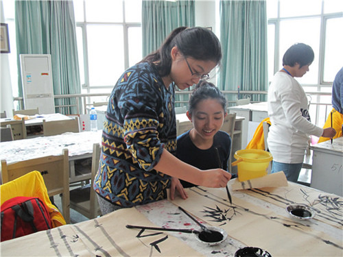 王老師在指導(dǎo)小營(yíng)員畫竹葉