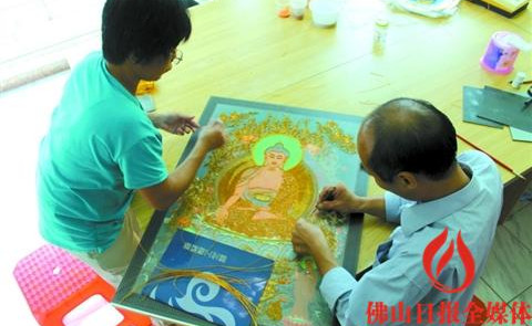 馮錫華(右)認(rèn)真制作掐絲琺瑯。