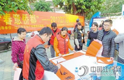 中國(guó)僑網(wǎng)名家為市民送春聯(lián)。