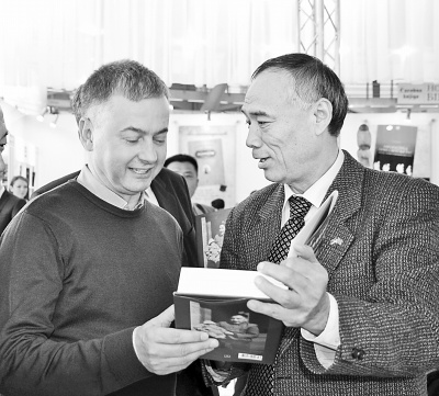 中國僑網(wǎng)圖為李滿長大使在塞爾維亞讀者的要求下為新書簽字。(戚德剛 攝)