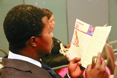 認真閱讀歡樂春節(jié)活動小冊子的貝寧記者。(西哈凡